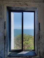 window frame with a view of sea in it with a vintage look 