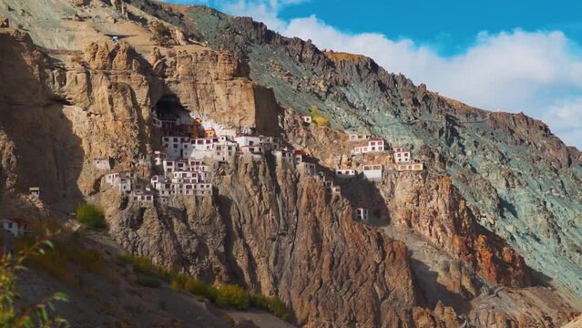 View of the Phugtal monastery built inside the mountain cave during the sunset near Purne in Zanskar Valley, Ladakh, India. Monastery built inside mountains in Zanskar. Remote monastery in India.
