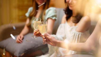Group of friends celebrating with champagne  Close up on hands.
