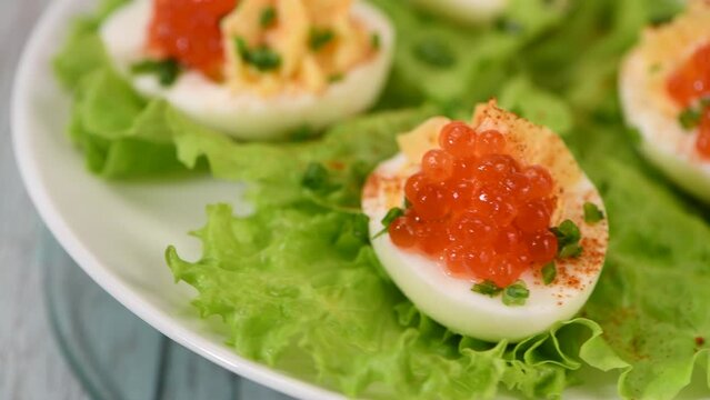 What a festive table without stuffed eggs, add piquancy in the form of red pepper and red caviar, and your appetizer will sparkle with a new taste. How to cook stuffed eggs.