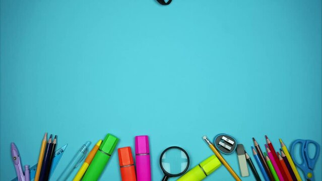 Pens, pencils, markers and other school accessories fall from the backpack in a row below. Stop motion