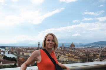 Fototapeta na wymiar Woman stands against the backdrop of the panorama of Florence, Italy.