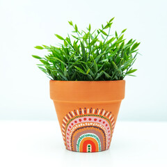Artificial plant in a clay terracotta pot. Ethnic motifs in the interior.
