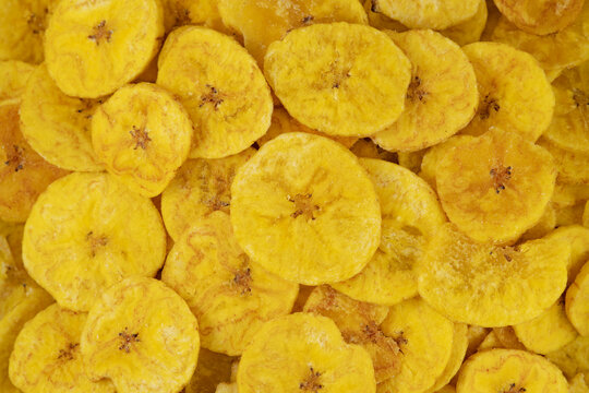 Pile of dehydrated fried banana chips with salt, top view. Chifles, tostones o patacones. Top view of typical traditional dish of Latin American gastronomy called Chifles or fried tostones. Platano.