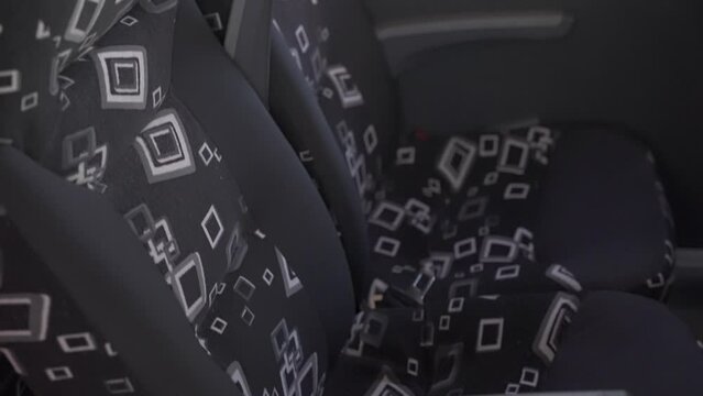 Close-up of comfortable empty black velvet seats in the passenger bus