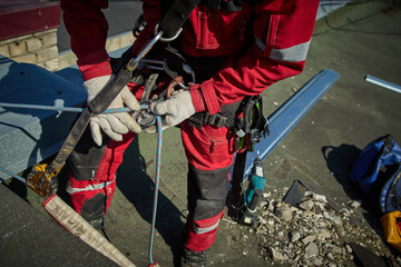 A specialist is repairing the roof. Rope access	