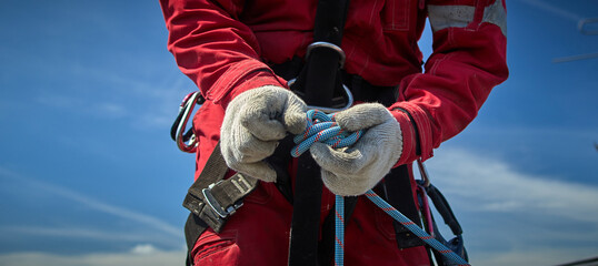 A specialist is repairing the roof. Rope access