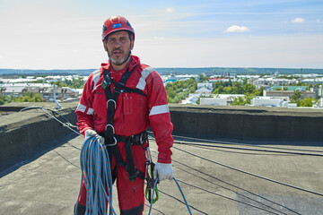 A specialist is repairing the roof. Rope access	