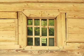 Small window of wooden hut in skansen Museum of Folk Architecture and Life "Shevchenkivskyi Grove" in Lviv, Ukraine