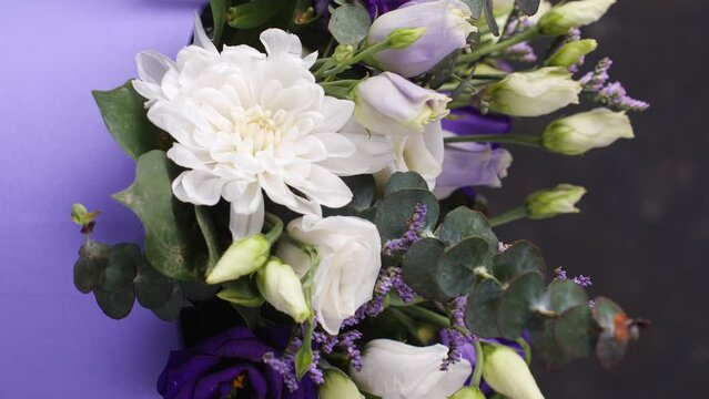 Beautiful composition, bouquet of white and blue roses. Close up. Copy space, vertical shot