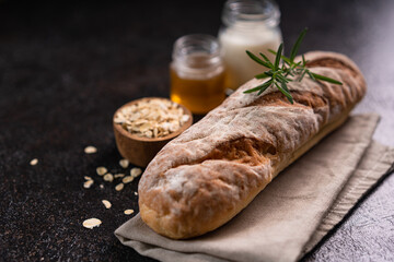 Fresh homemade artisan loaf of baguette breads on rustic background with copy space. sourdough mini baguette breads.