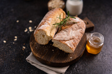 Fresh homemade artisan loaf of baguette breads on rustic background with copy space. sourdough mini baguette breads.