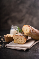 Fresh homemade artisan loaf of baguette breads on rustic background with copy space. sourdough mini baguette breads.