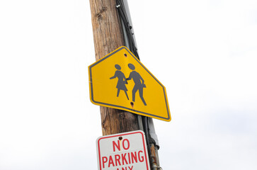 Vibrant yellow pedestrian sign stands tall, symbolizing safety, alertness, and the importance of pedestrian rights in urban environments