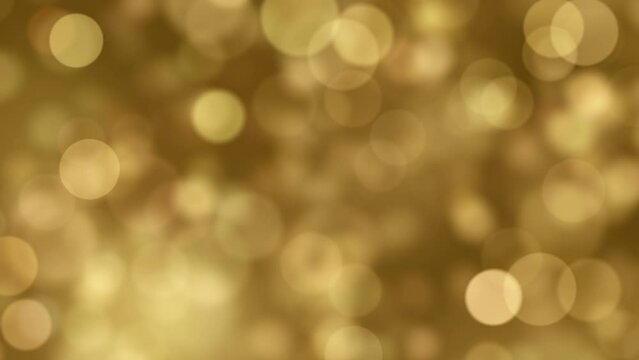 Abstract Christmas background of a blurred bokeh of animated golden light particles in a seamless loop
