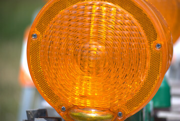 The orange lens of a construction barricade light.