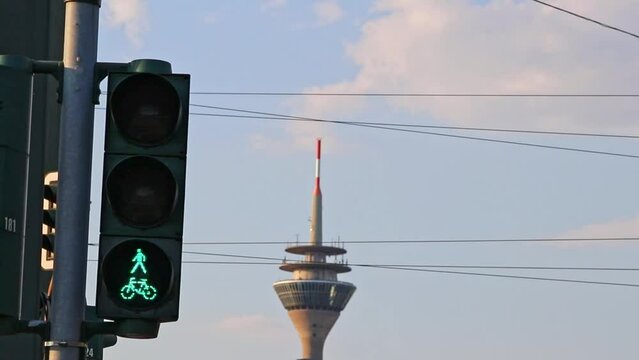 Traffic lights for bikes and pedestrians changing from red traffic light to green traffic light for bikers shows city street from bicycle point of view in Düsseldorf switching from red to green