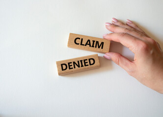 Claim denied symbol. Wooden blocks with words Claim denied. Businessman hand. Beautiful white...