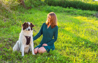 A young woman with her white dog.