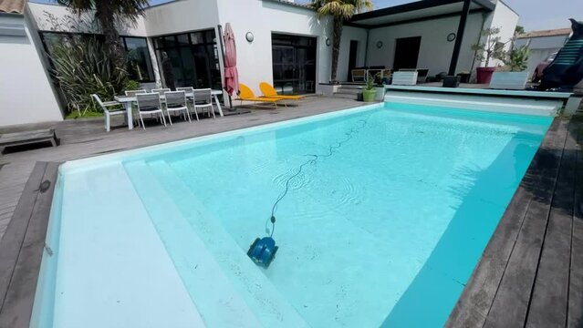  Underwater pool vacuum cleaner. Robotic cleaning of the pool floor. Pool cleaner robot Pool maintenance with automatic robot. Cleaning the bottom and walls with a submersible robot