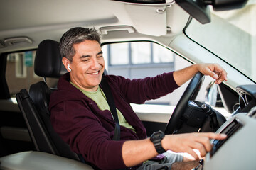 Middle aged latin man driving a car in the city