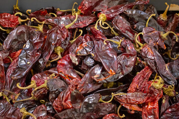 A view of a bin full of dried chile New Mexico, on display at a local grocery store.