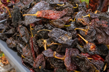 A view of a bin full of dried chile pasilla, seen at a local grocery store.