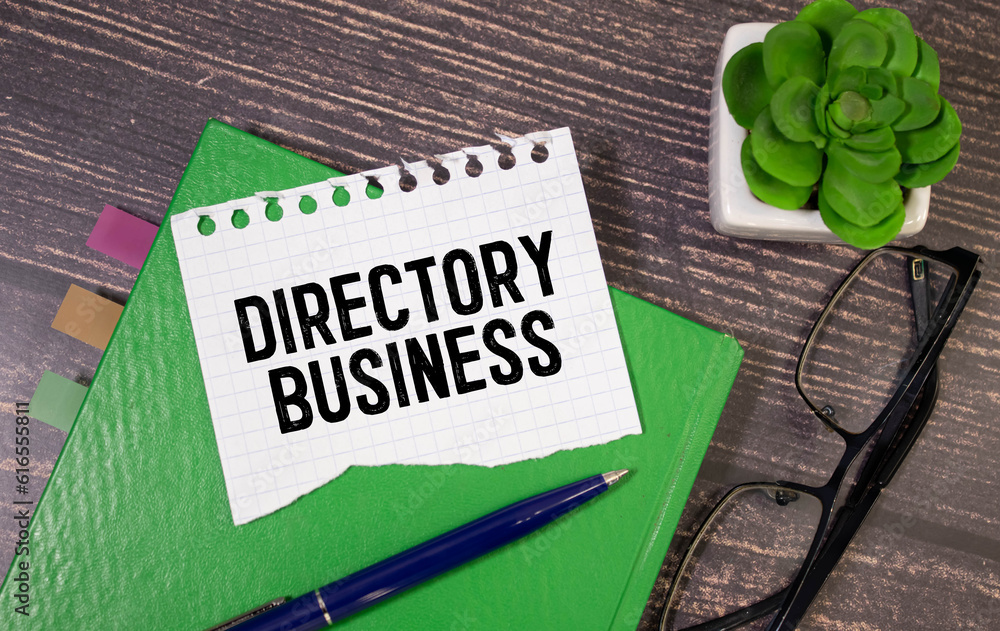 Poster in the notebook is the text of directory business, next to a pencil and calculator, reports and grap