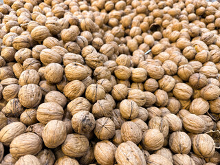 A view of a bin full of walnuts, on display at a local grocery store.
