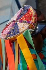 multicolored decoration on the cap and ribbons in the traditional folkloric manifestation of the congada de Santa Ifigênia on the feast of Our Lady of Rosary of Black Men. São Paulo Brazil