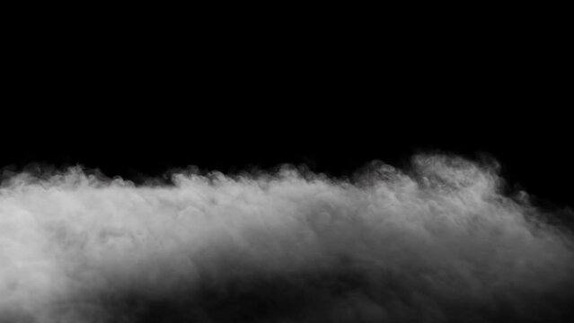 Thick ground fog slowly moving forward - isolated on black background - VFX element - 4K Pro Res