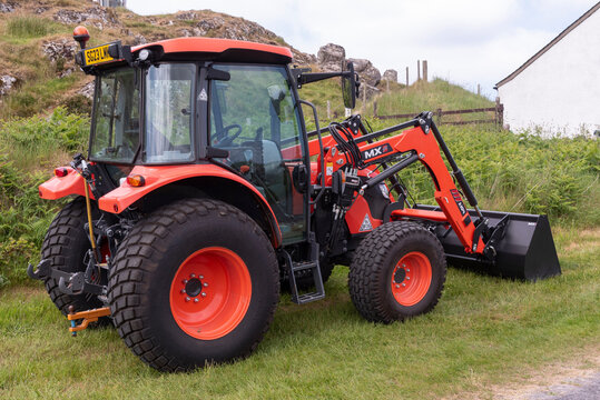 Isle of Iona, Western Isles, Scotland,  June 6 2023. A red tractor and grab new and just delivered. No vehicles are allowed on Iona unless you are a resident.