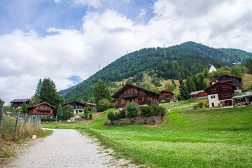 Fototapeta na wymiar Mountain village in Alps, Switzerland. Summer landscape with mountain village.