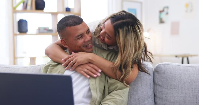 Laptop, hug and happy couple on sofa in home living room, bonding or having fun. Computer, relax and man and woman smile while streaming movie, video or typing email online on social media together.