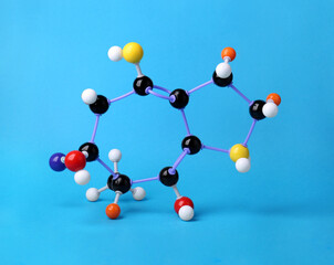 Structure of molecule on light blue background. Chemical model