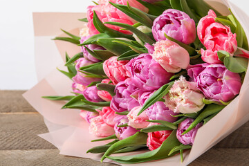 Bouquet of beautiful tulips on wooden table, closeup