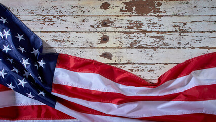 American Flag for America's 4th of July Celebration over a white wooden rustic background to mark America's Independence Day. Image shot from the top view