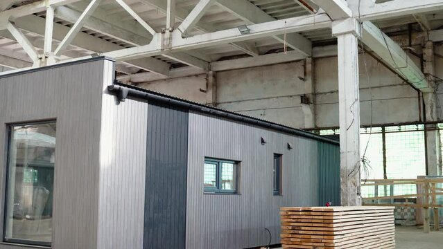 A new modular house for a small office inside an industrial building