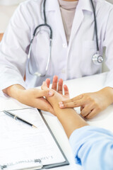 Doctor hand examines the patient's pulse and records the results, health medical checkup concept