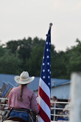 Cowgirl with an American Flag at a Rodeo