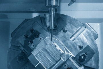 The 5-axis CNC milling machine cutting the automotive parts with ball end mill tool.