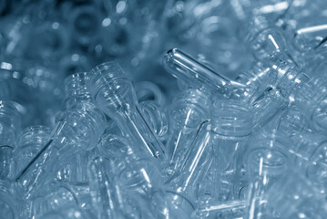 Close up scene of pile of preform shape of PET bottle products.