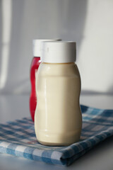 close up of Mayonnaise in container on table .