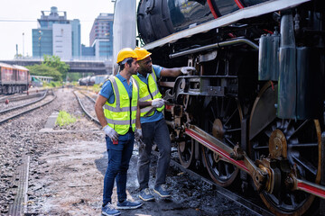 Engineer railway wearing safety gear checking train transmittal system for safety travel passenger