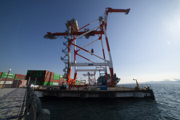 Fototapeta na wymiar Containers and cranes near the port in Aomi Tokyo wide shot