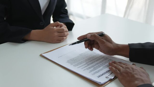 Business people signing a contract to buy or sell real estate.