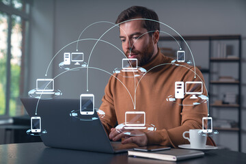 Thoughtful businessman in casual wear typing on laptop at office workplace. Concept of distant...