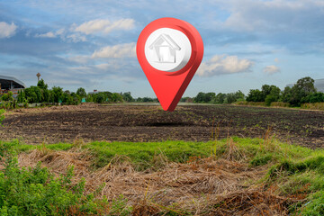 House symbol with location pin icon on empty dry cracked swamp reclamation soil in real estate sale...