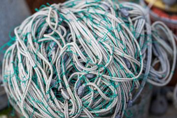 Close up of a rolled up fishing net in the harbor