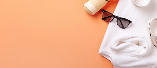 A pair of sunglasses, a cup of coffee and a towel on an orange background created with Generative AI technology